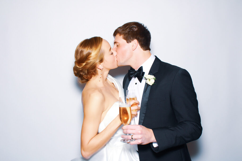 bride and groom kissing color glam photo booth
